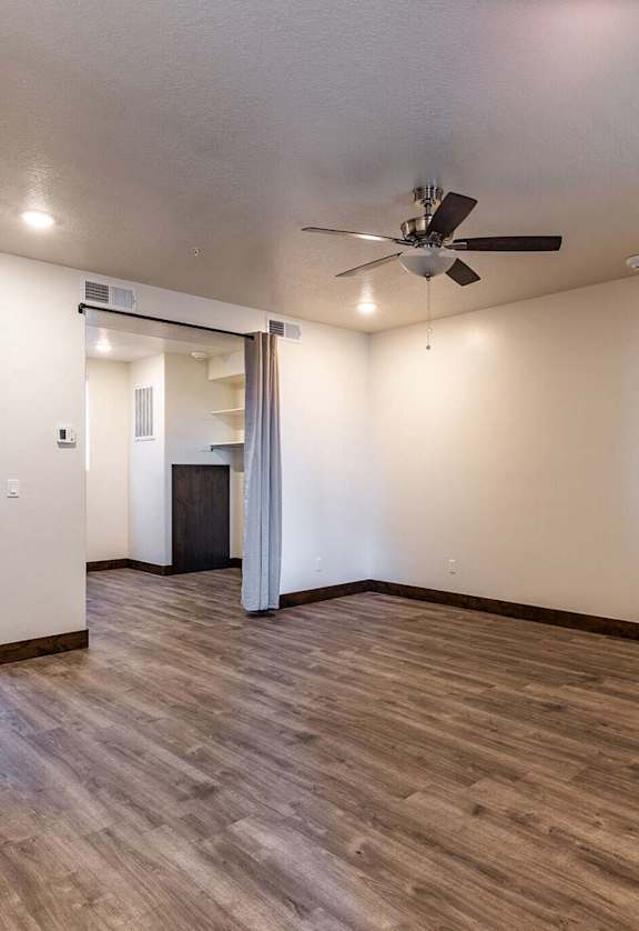 a living room with hardwood floors and white walls