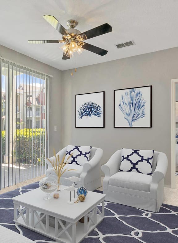 a living room with a couch and coffee table in front of a large window with a pool at Bella Vista on Park, Plant City, 33563