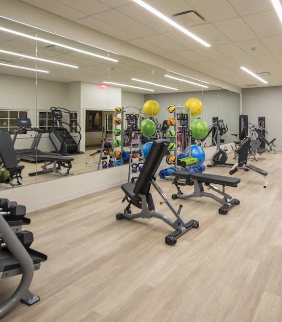 A gym with a variety of equipment including treadmills, weights, and exercise machines. at The Pennsylvanian Apartments, Pittsburgh, Pennsylvania