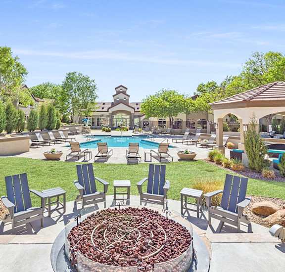 an outdoor patio with chairs and a swimming pool