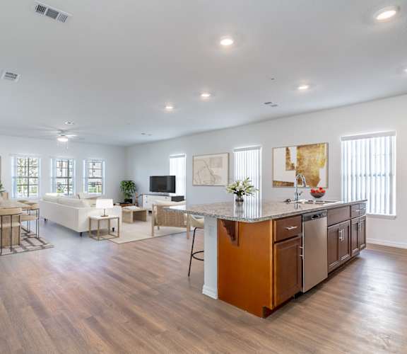 A spacious kitchen with wooden floors and a large island.