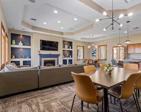 A modern dining room with a large table and chairs.