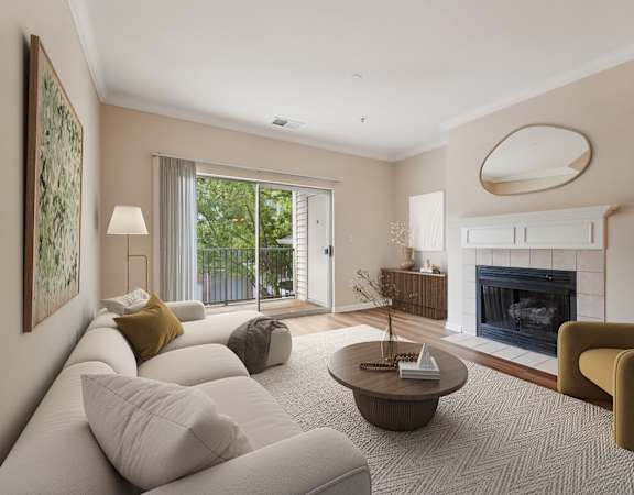 A living room with a fireplace and a painting on the wall.