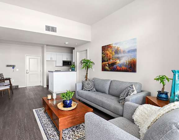 a living room with a gray couch and a wooden coffee table