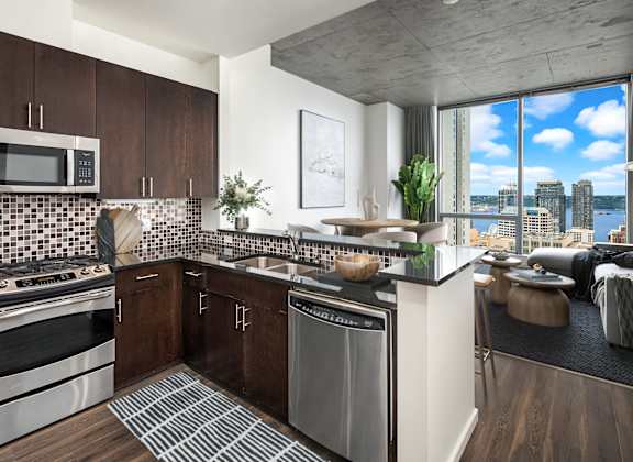 A modern kitchen with dark wood cabinets and a stainless steel dishwasher.