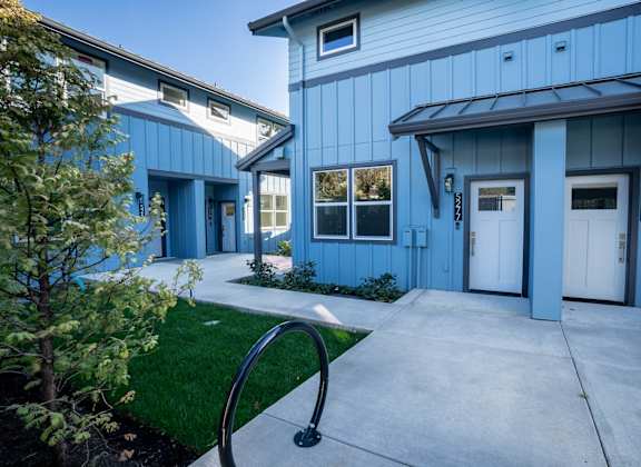 A blue building with white doors and windows.