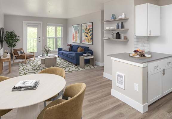 A modern kitchen with a dining table and chairs.