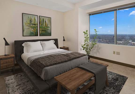 a bedroom with a bed and a large window