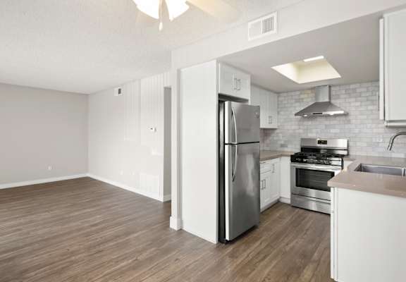 A kitchen with a refrigerator, stove, and oven.