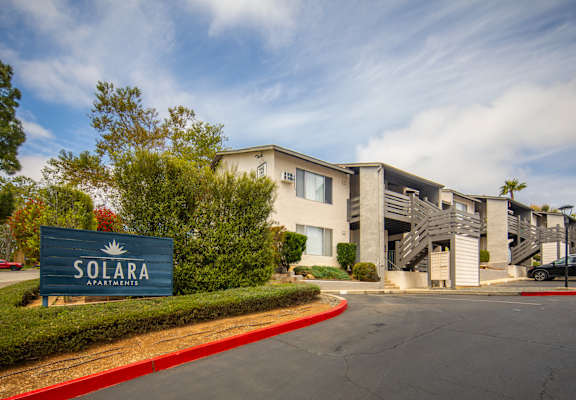 The image shows a building with a sign that reads "SOLARA APARTMENTS".
