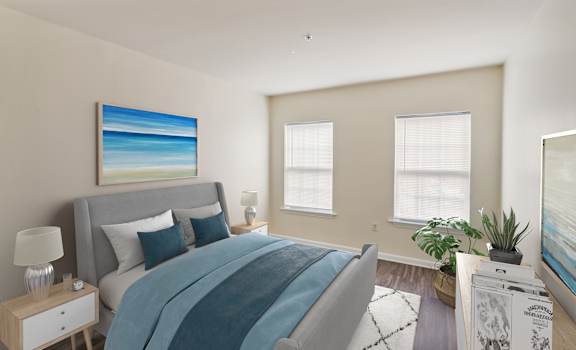 a bedroom with a bed and two windows at Highlands at Faxon Woods, Quincy, MA