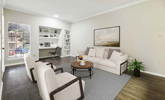 a living room with a couch and chairs and a table