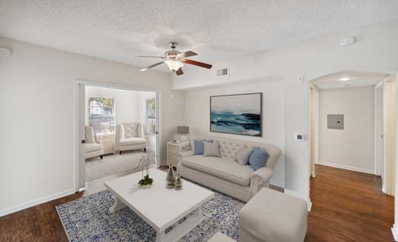 a living room with a couch and a coffee table and a ceiling fan at Via Lugano, Boynton Beach, FL, 33436