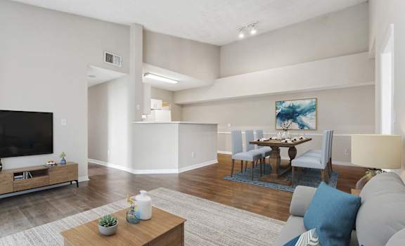 a living room and dining room with a table and a television at Cypress Shores, Coconut Creek, FL, 33063