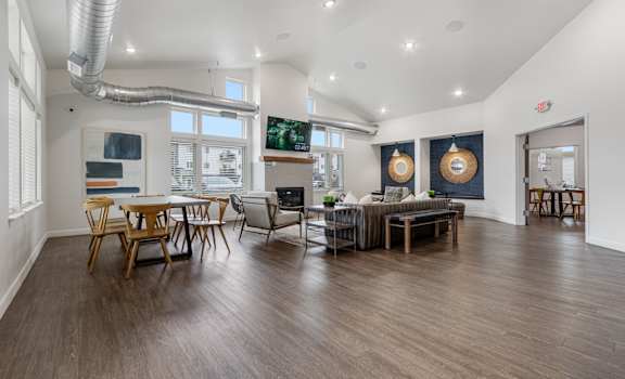 A modern living room with wooden floors and furniture.