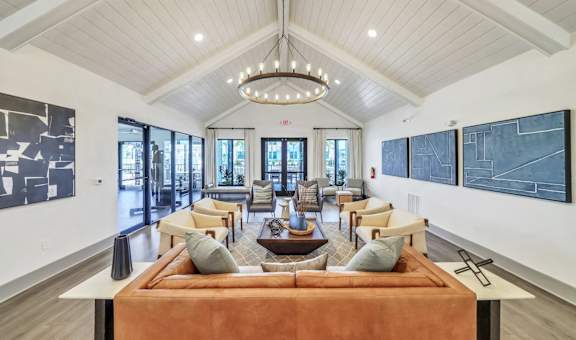 a living room with couches and chairs and a chandelier