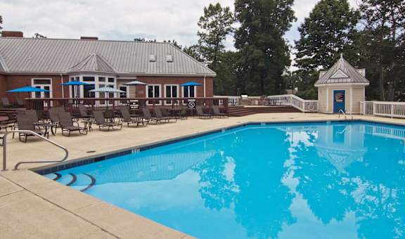 the swimming pool at our hotel with chairs around it