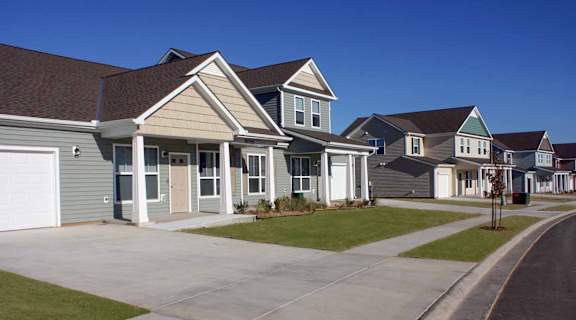 A row of houses with a clear blue sky above them.