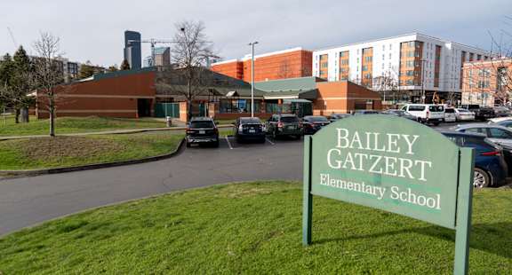 Bailey Gatzert Elementary School is a small building with a green sign in front of it.