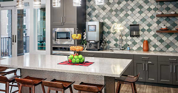 a kitchen with a marble counter top and bar stools