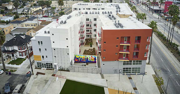 an aerial view of a building with a mural on the side of it