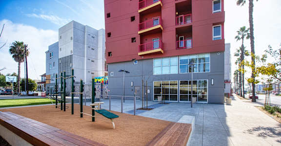a communal area with benches in front of a building