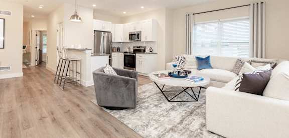 A modern living room with a grey sofa and a coffee table.