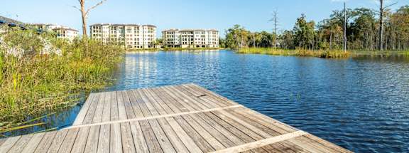 Mandarin Bay Apartments dock on a river with buildings in the background