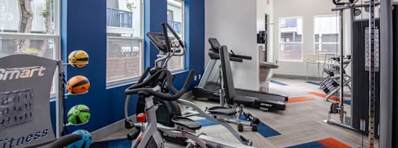 Stadium 700 gym with treadmills and other exercise equipment in a building with blue walls