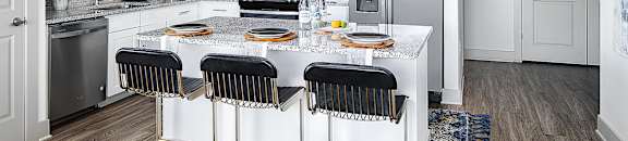 A kitchen with white cabinets and a black stove top. at Berewick Pointe Apartments , Charlotte