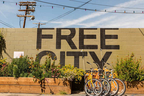 A wall with the words "FREE CITY" painted on it.