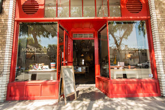 A red storefront with a sign that says "Max & Moritz" and "Not a General Store".
