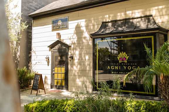 A sign on a building reads "AGNI YOGA".