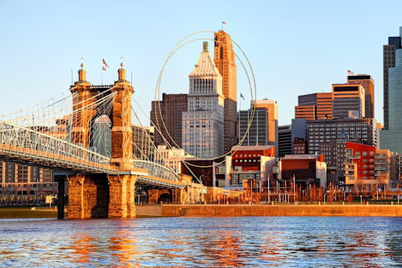 A cityscape with a bridge and buildings in the background.