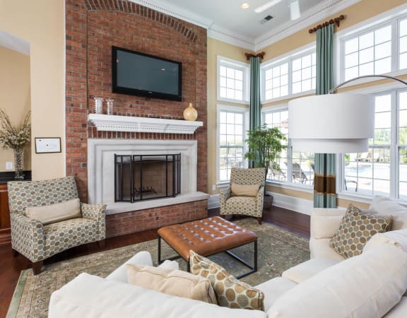 a living room with a white couch and a brick fireplace