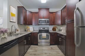 a kitchen with stainless steel appliances and wooden cabinets