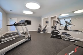 a gym with treadmills and other exercise equipment