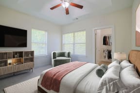 a bedroom with a large bed and a ceiling fan