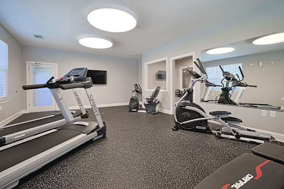 a gym with treadmills and other exercise equipment