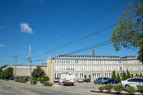 A large building with a parking lot in front of it.