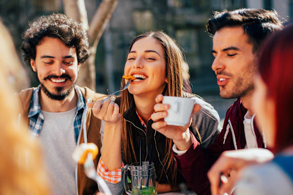 A group of people enjoying a meal together outdoors.