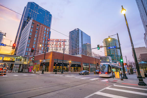 A city street with a tram and cars.