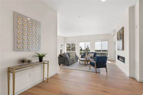 A living room with a grey couch and a gold console table.