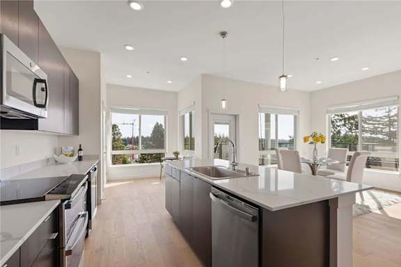 A modern kitchen with a large island and stainless steel appliances.