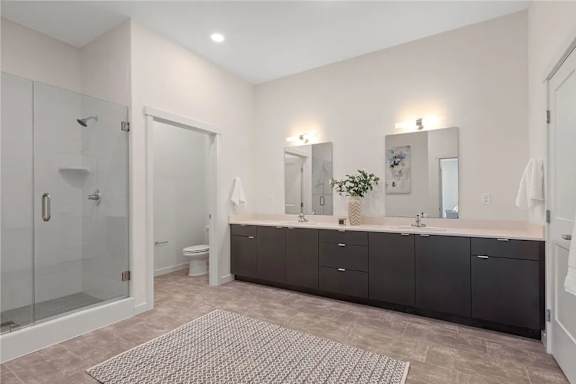 A bathroom with a walk-in shower, double sinks, and a large mirror.