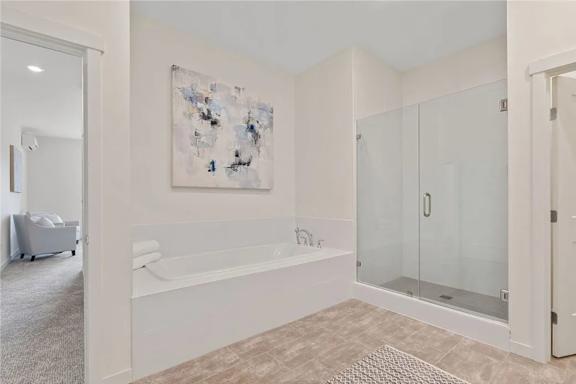 A bathroom with a large tub and a painting on the wall.