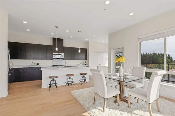 A modern kitchen with a dining table set for four.