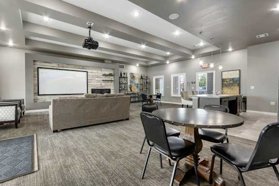 A modern living room with a grey sofa, a black coffee table, and a television.