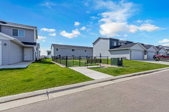 A row of houses with a clear blue sky above them.