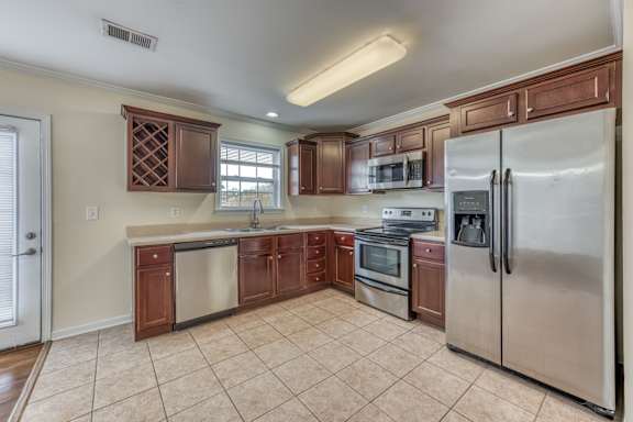 a kitchen with stainless steel appliances and wooden cabinets
